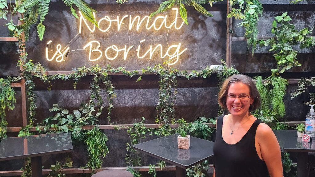 Ruth Kalinka with Normal is Boring sign in Athens WCEU 2023